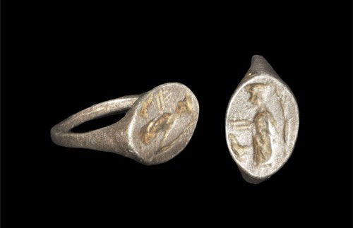 Silver Engraved Intaglio Ring: An undated Roman-style silver D-shaped finger ring with round-section hoop and elliptical bezel with engraved intaglio depicting a bearded male with extended arms. Silver, 5.41 grams, 21 mm overall (a