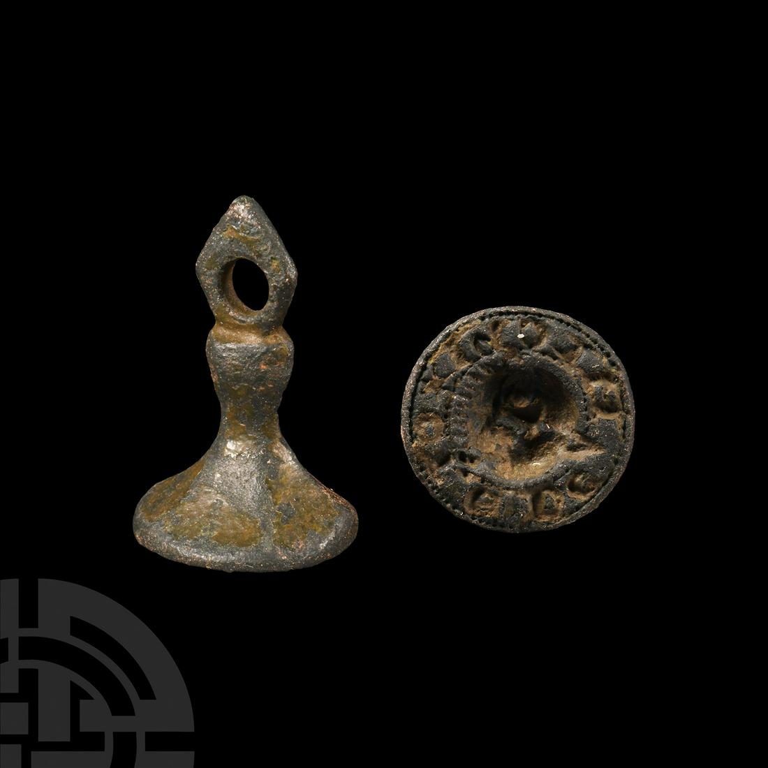 Medieval Lion Mask Seal Matrix: 14th century A.D. Featuring a facetted hexagonal shank with lozenge-shaped pierced terminal, discoid matric bearing incuse design of a lion or beast's head facing and sticking its tongue out; surround