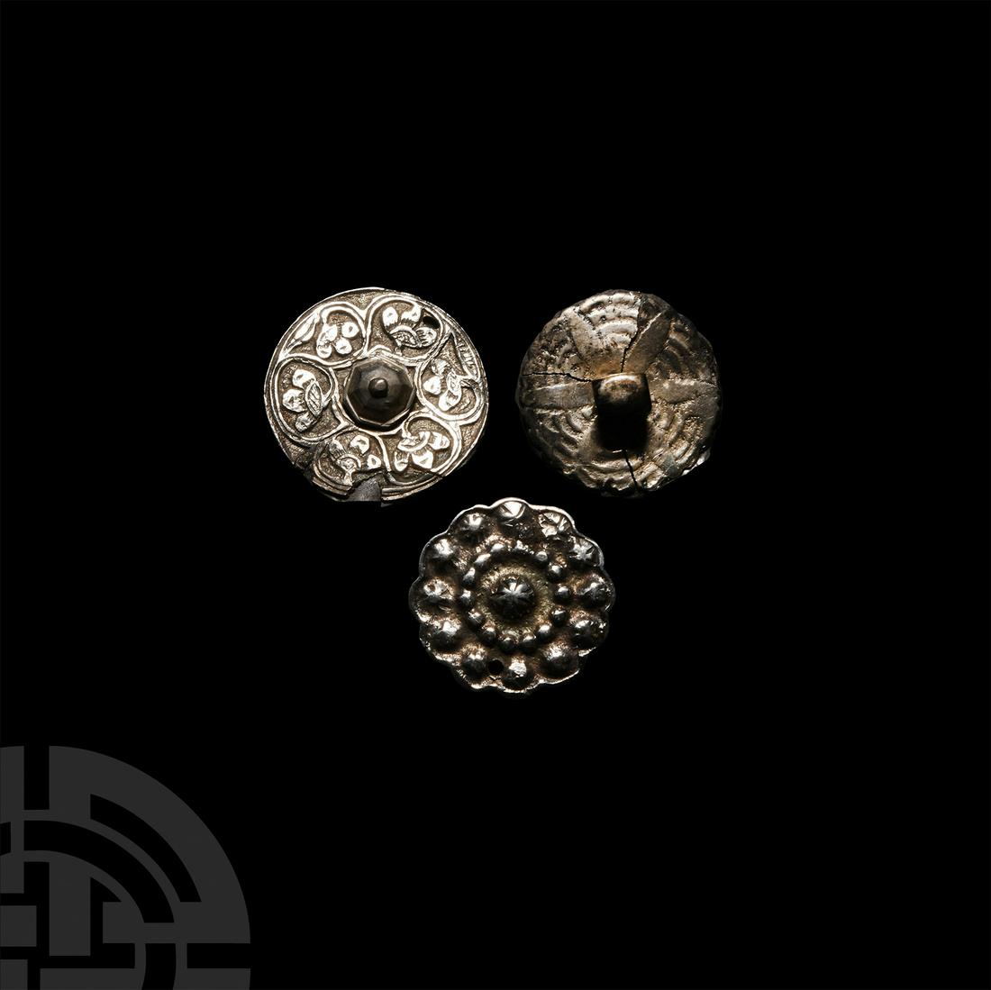 Medieval Silver Ornate Roundel Group: 14th-15th century A.D. Comprising three silver discs bearing stylised floral motifs in repoussé, chasing and relief; some repairs. 22.3 grams total, 28-32 mm (1 1/8 - 1 1/4 in.). English private coll