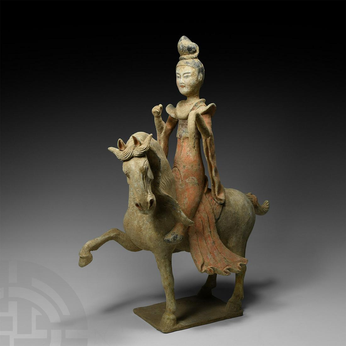 Large Chinese Tang Lady on Striding Horse: Tang Dynasty, 618-907 A.D. Modelled in the round; the horse in advancing pose with one foreleg raised, copious mane; the female rider with upright posture, wearing an ankle-length coral-coloured robe