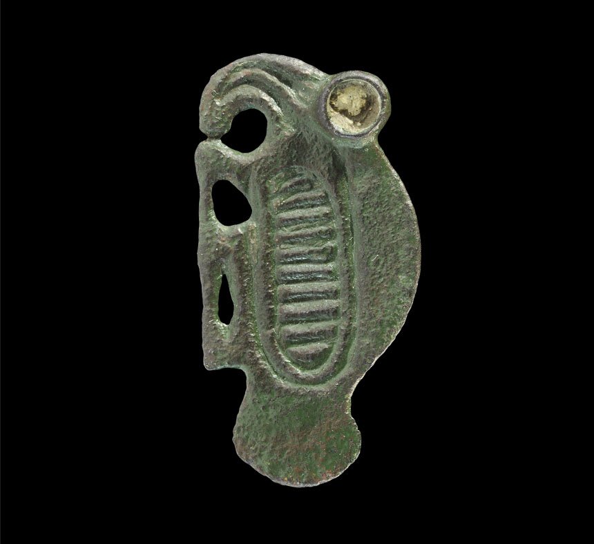 Merovingian Frankish Bronze Bird Brooch: Circa 6th century AD. A cast bronze bird brooch with ribbed panel for the wing, cloison eye; the bird facing left, catchplate and pin-lug to the reverse. Property of a Middlesex Gentleman; acquired in