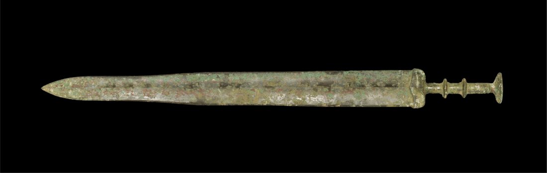 Chinese Bronze Han Dynasty Sword: Han Dynasty, 206 BC-220 AD. A cast bronze short sword with central midrib to the tapering blade; transverse discoid ribs to the grip and large discoid pommel above. Property of a London Gentleman; acq