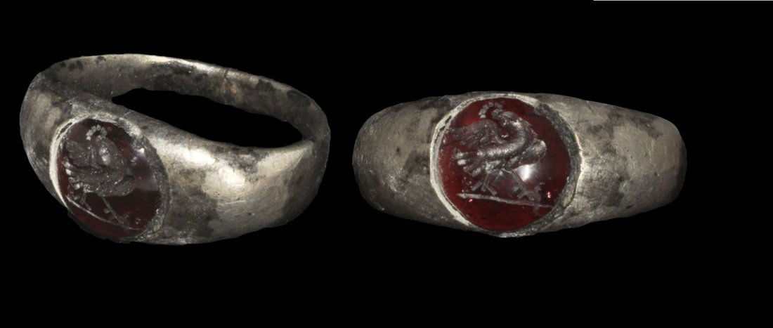 Roman Silver Intaglio Ring: Circa 1st-2nd century AD. A silver finger ring with expanding D-section hoop; to the bezel ac onvex red stone intaglio depicting a bird. Private collection, Nottinghamshire, UK; acquired late 1980's -