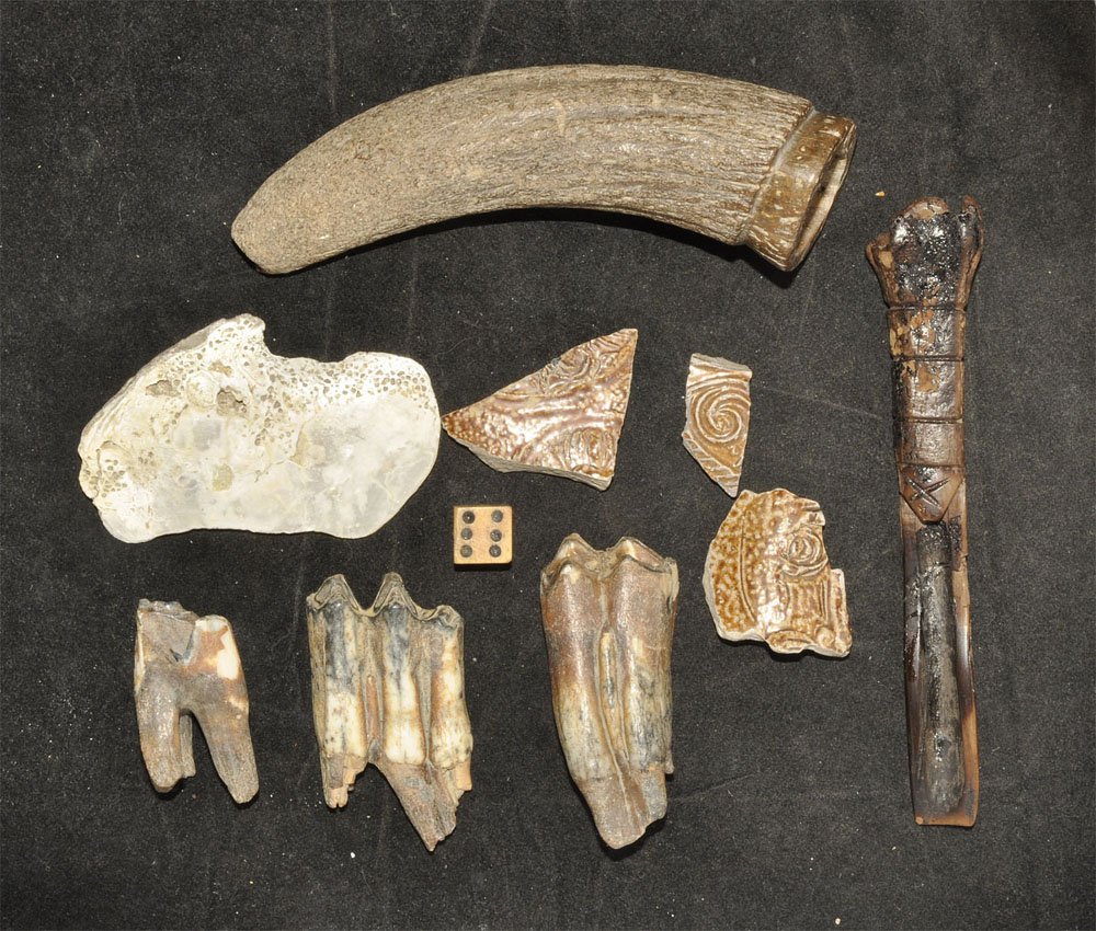 Post Medieval Excavated Caribbean Items Group: Circa 17th century AD. A mixed group of excavated items from a site in the Caribbean comprising: a horn with worked upper end; three bovine teeth; three fragments of tin-glazed ceramic from a belarmin