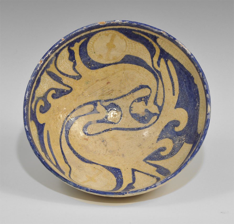 Islamic Persian Style Ceramic Peacock Bowl: A undated cream-glazed ceramic bowl with pedestal; blue glaze design to the inner face depicting two peacocks in reserve; Aghkand workmanship. Acquired on the London art market in the 1960's. Ceramic,