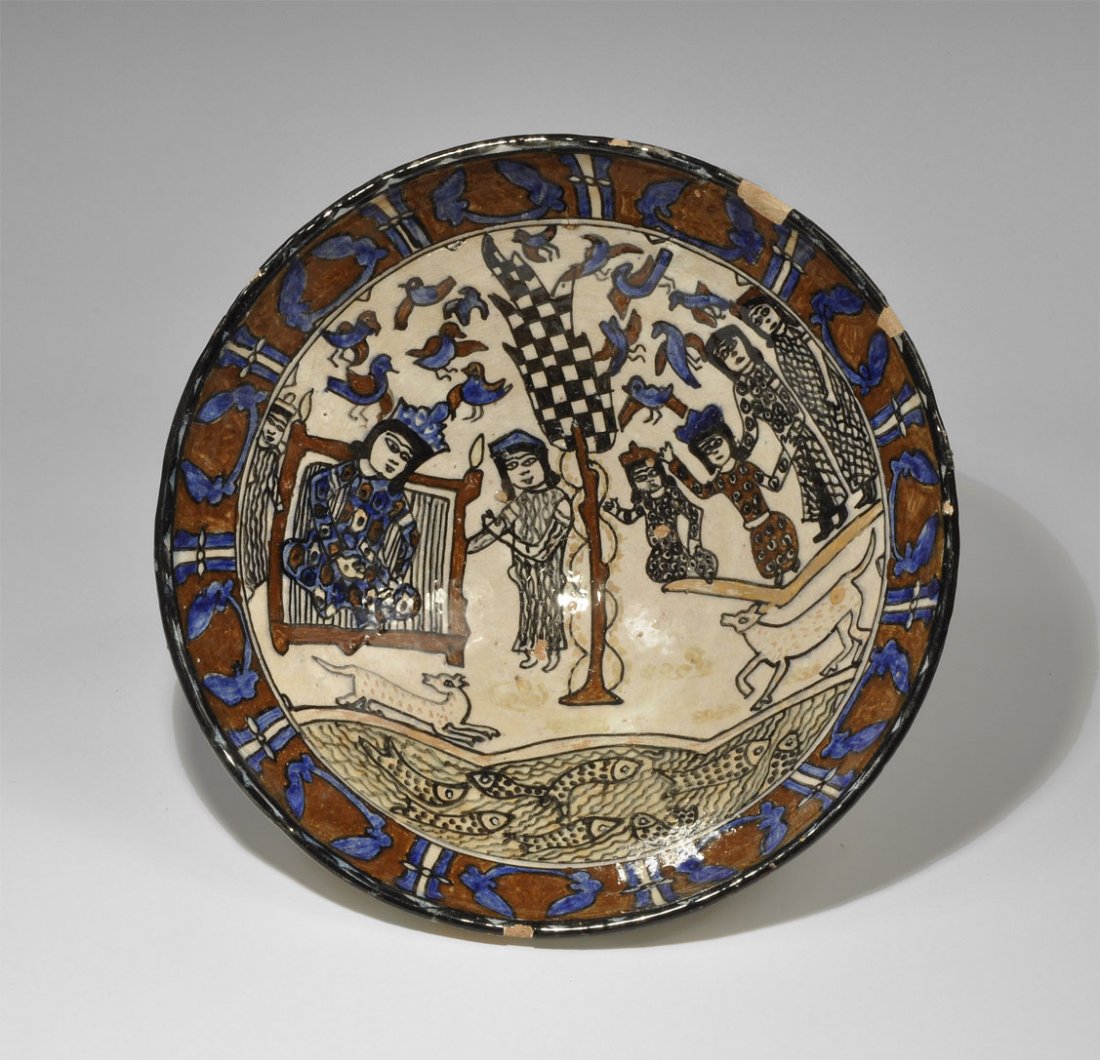 Islamic Persian Style Figural Bowl: An undated bowl with low basal ring, the inner face bearing a polychrome scene comprising: a maroon border with blue crescent motifs and blue and white columns; a central tree with black and white che