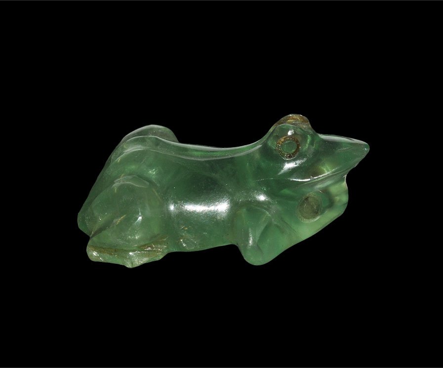 Indian Beryl Frog Pendant: Moghul, 17th century AD. A carved beryl frog pendant with a loop beneath the chin. Acquired on the London art market in the late 1990's. Stone, 12 grams, 35 mm (1 1/2").