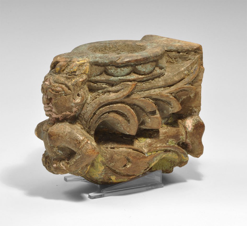 Far Eastern Wooden Flying Angel Incense Burner Bracket: Circa 18th century AD. A carved wooden incense burner formed as a Buddhist flying angel with winged and plumed costume and recessed panel behind. Ex Steinberg collection Wood, 638 grams, 15.5 cm (6").