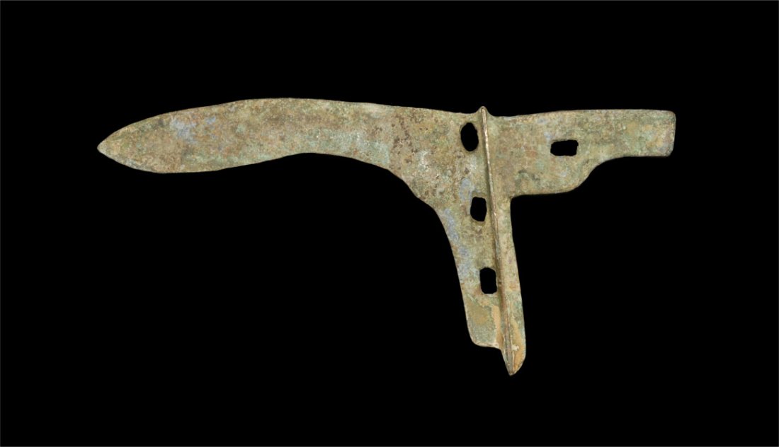Chinese Bronze Warring States Halberd: Warring States Period, 475-221 BC. A cast bronze halberd blade with median rib, curved blade to one side, piercings for attachment Ex-McQuinley Collection; acquired on the London art market before 200