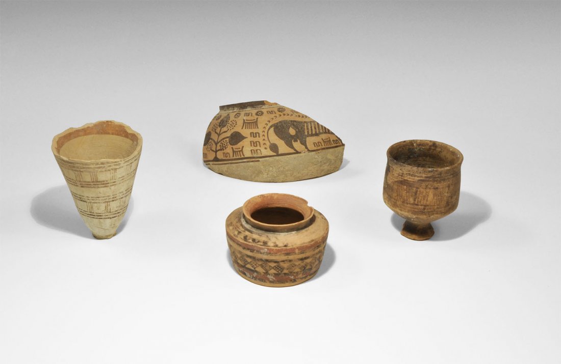 Indus Valley Ceramic Vessel Group: Circa 2nd millennium BC. A mixed group of ceramic painted vessels and a fragment, comprising: one conical creamware cup with bands of brown painted concentric rings and vertical lines; one terracotta