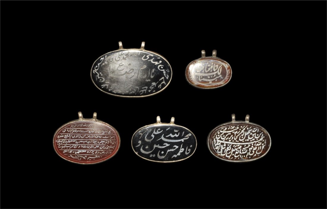 Indian Himalayan Islamic Calligraphic Pendants: 19th century AD. Five ovoid agate pendants in white metal mounts, each with a calligraphic inscription. London private collection, acquired 1950's-1970's. Agate and metal, 35 grams total, 25 - 42 mm (