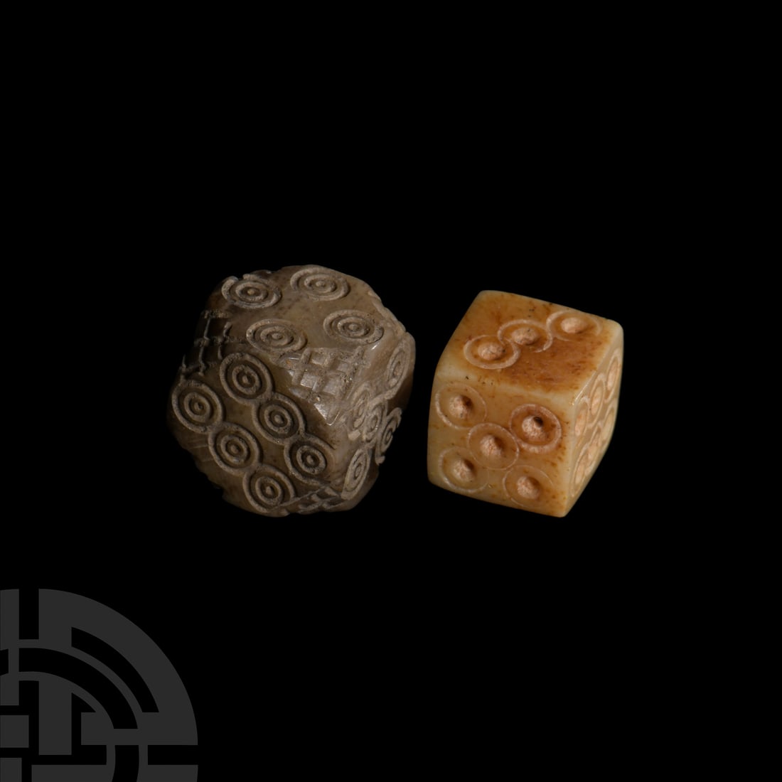 Roman Bone Dice Pair: 1st-4th century A.D. Comprising: one with ring-and-dot markings disposed 1:6, 2:5, 3:4; the other a cornerless cuboid with hatching to the corners, and markings disposed in a similar way. 2.31 grams t