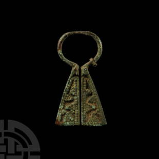 Viking Inspired Bronze Omega Penannular Brooch: Circa 13th century A.D. Of Mordvinian type comprising a round-section hoop and two trapezoidal plate finials each with a geometric design of granulation; remains of round-section pin coiled to the hoo