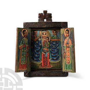 Ethiopian Wooden Painted Triptych Icon: 20th century A.D. With hand-painted scenes to the inner faces, the central panel with nimbate Mary holding Jesus, the child making a blessing sign with his right hand and holding a book in his left; M