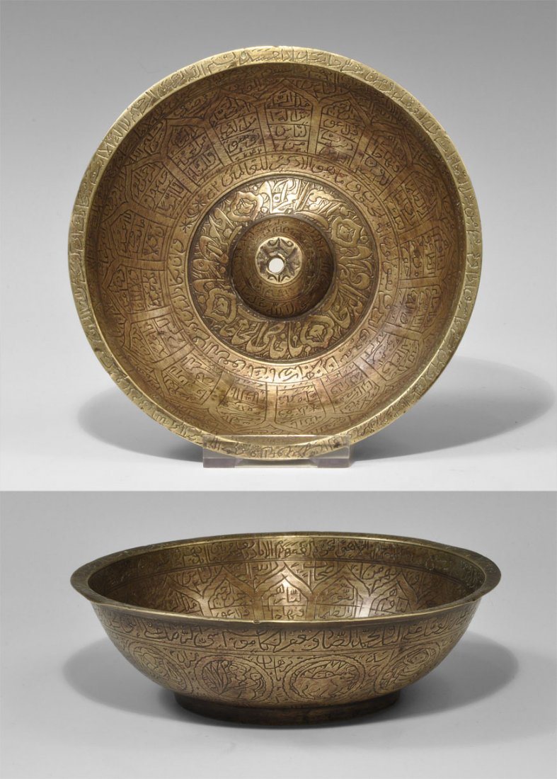 Islamic Bronze Epigraphic Zodiac Musical Bowl: Circa 18th-19th century AD. A bronze musical bowl with everted rim, low basal ring and central conical boss; the exterior with signs of the zodiac within annular frames between two bands of text; the 