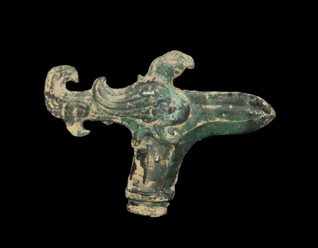 Chinese Bronze Zhou Period Socketted Halberd: Zhou Dynasty 1046–256 BC. A cast bronze halberd with elliptical socket and L-shaped blade, bird-shaped finial to the reverse. UK art market, acquired prior to 1985. Bronze, 236 grams, 15 cm (5 3/4")