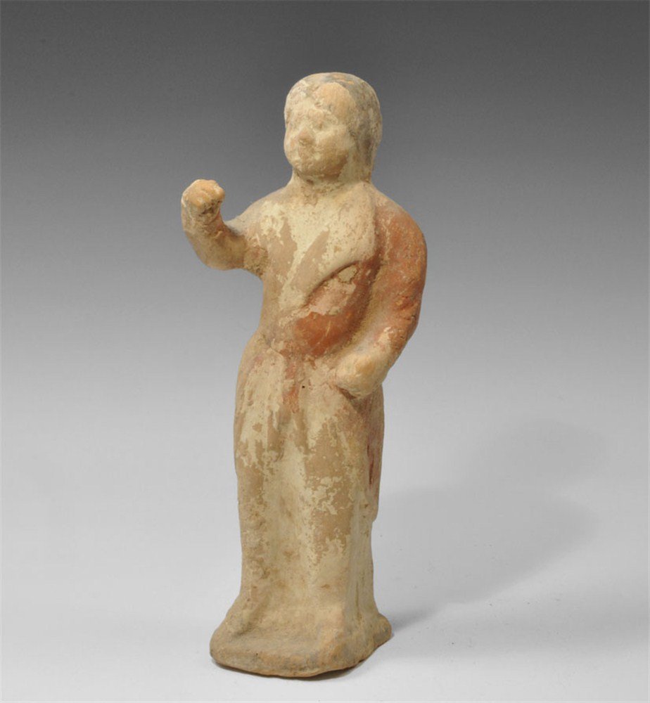 Chinese Ceramic Tang Dynasty Painted Horseman Figurine: Tang Dynasty, 618-906 AD. A ceramic figurine depicting a standing male on a square base in a short riding coat with the left hand at the side and the right hand raised; red pigment to the body, black