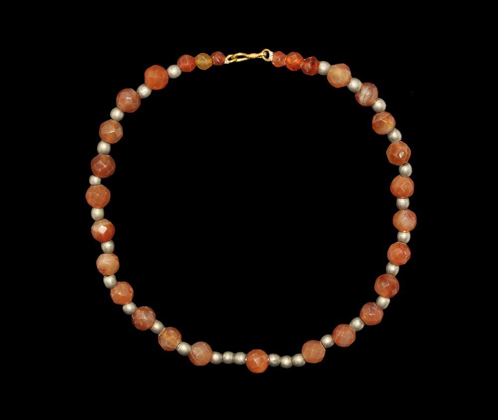 Islamic Cut Carnelian and SIlver Bead Necklace: Circa 13th century AD. A restrung necklace of facetted carnelian beads and spherical silver spacer beads; modern fastening. Carnelian and silver, 70 grams, 48.5 cm (19"). From an old London collection