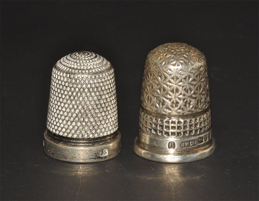 Post Medieval Two Decorated Silver Thimbles: 19th century AD. A pair of silver thimbles comprising one with design of raised concentric circles to the dome and regular milled indentations to the entire exterior (Birmingham assay office, 1814, si