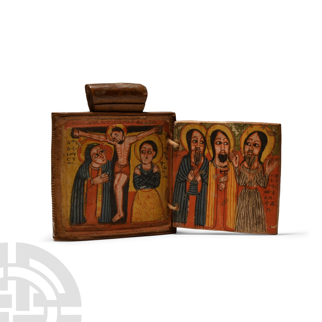 Ethiopian Diptych Icon of the Crucifixion and Saints: Circa 1680 A.D.. Carved rectangular diptych with pierced suspension bar above and braided thread hinges; obverse with ornate reserved cross on a field with concentric chip-carved borders; reverse with
