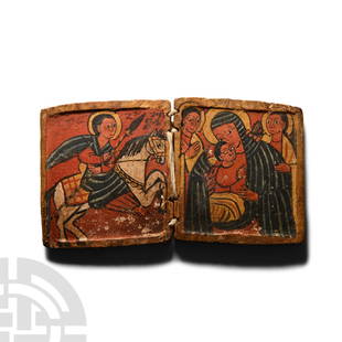 Ethiopian Diptych Icon of the Virgin and Child with Angels and Saint George: Circa 1500 A.D.. Carved rectangular diptych with braided thread hinges; left inner panel a painted scene of the St. George on horseback wielding a spear with Ge'ez script text above; right panel with