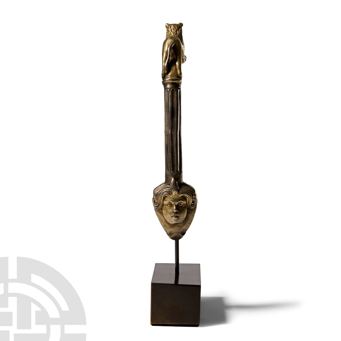 Post Classical Gilt Silver Handle with Lion and Mask: Circa 18th century A.D.. Of fluted columnar form with the upper part formed as a lion leaping forward with its forepaws resting on the rim of the vessel; ovoid attachment plate at the lower end with m