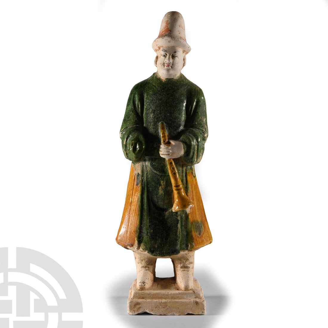 Chinese Ming Glazed Terracotta Tomb Attendant: Ming Dynasty, 1368-1644 A.D. or later. Modelled standing with the right hand inside the sleeve, left hand held to the chest holding a trumpet; on a tiered base. See Bower, V., From Court to Caravan: C