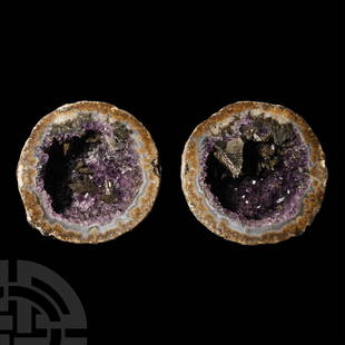 Natural History - Cut and Polished Amethyst Crystal Geode Pair.: Spherical geode cut in half to expose the internal cavity filled with dark purple prismatic amethyst crystals and large quartz crystals with goethite(?). 1.07 kg total, 10.2-10.6 cm (4 - 4 1/4 in.).