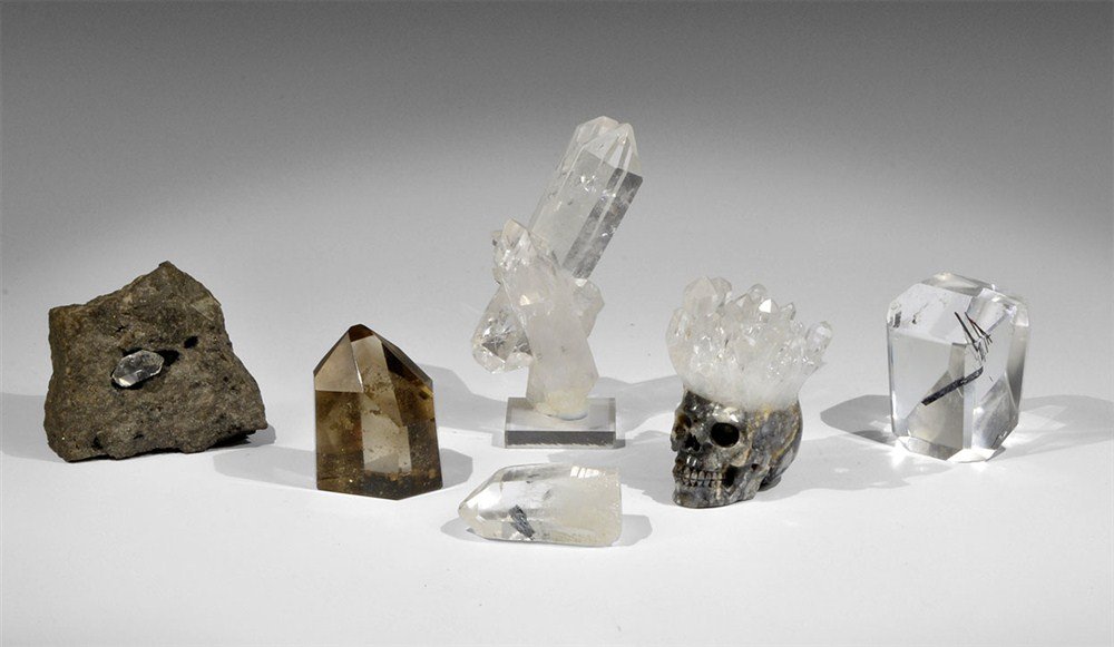 Collection of Quartz Mineral Specimens: Group of five quartz mineral specimens comprising; a 'herkimer diamond' in matrix, a cluster (with stand), an agate skull with a crystal 'crown', a polished smoky quartz phantom (natural crystal with 