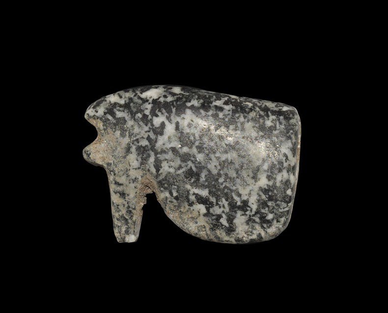 Egyptian Granite Eye of Horus Amulet Pendant: New Kingdom, 1550-1070 BC A black and white speckled granite wedjat or Eye of Horus pendant, the surface uncarved; drilled lengthways for suspension. 11 grams, 30 mm. (1 1/4"). From the Foxwell family