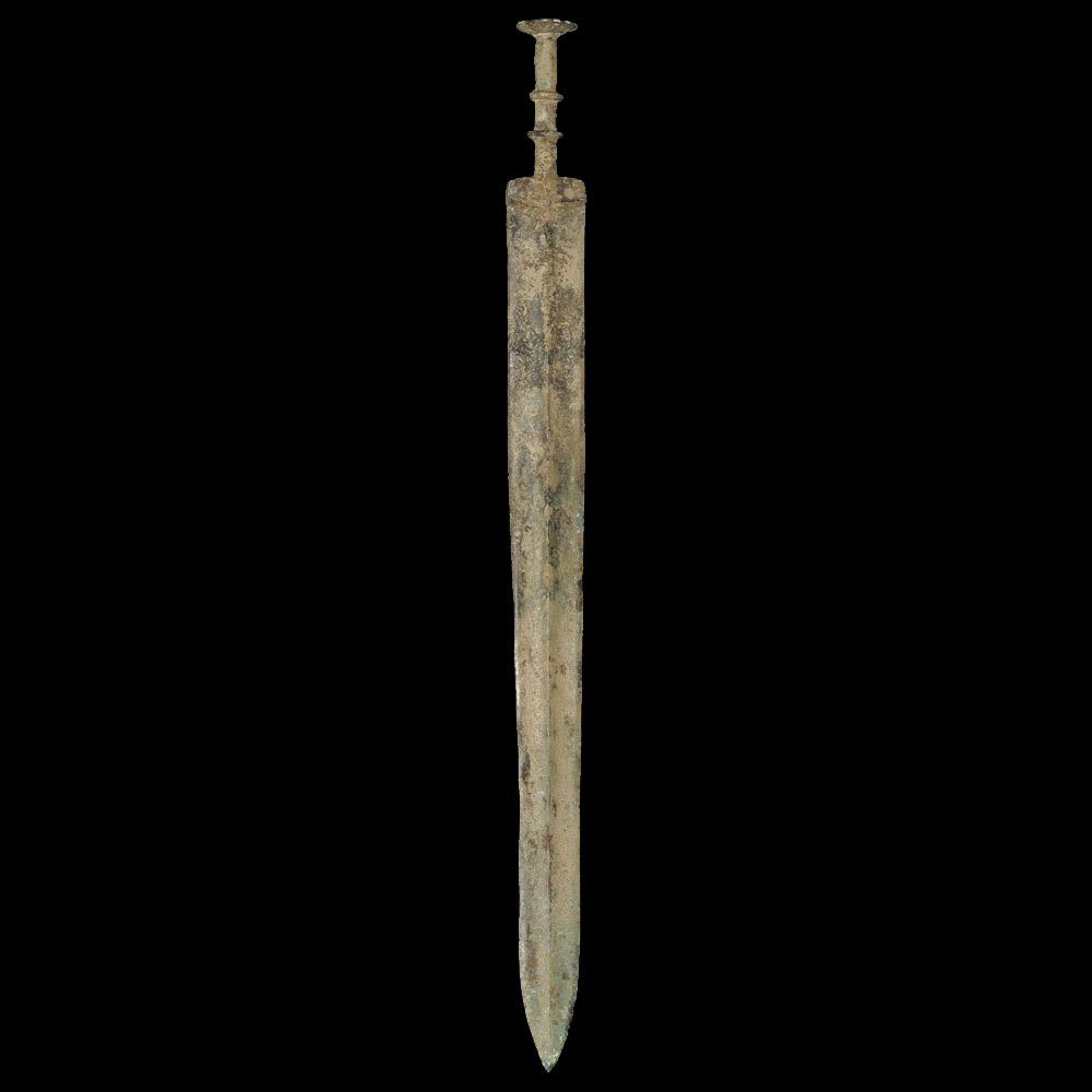 Chinese Bronze Sword: Han Dynasty, 206 BC-220 AD A cast short sword with slightly tapered blade, integral guard and hilt; the blade lozenge-section with median rib; rectangular guard with cast scrolling pattern; the grip c