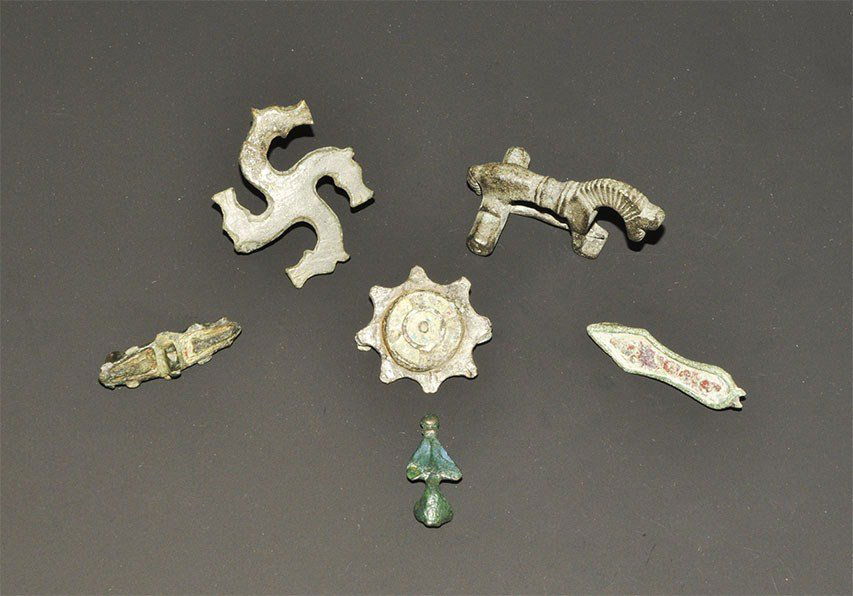 Roman Bronze Brooch Group: 2nd-4th century AD. A mixed group of bronze brooches comprising: a horse-head gammadion type; an enamelled disc type with spokes; an equal-ended type with enamel panels; a substantial horse type; a sa