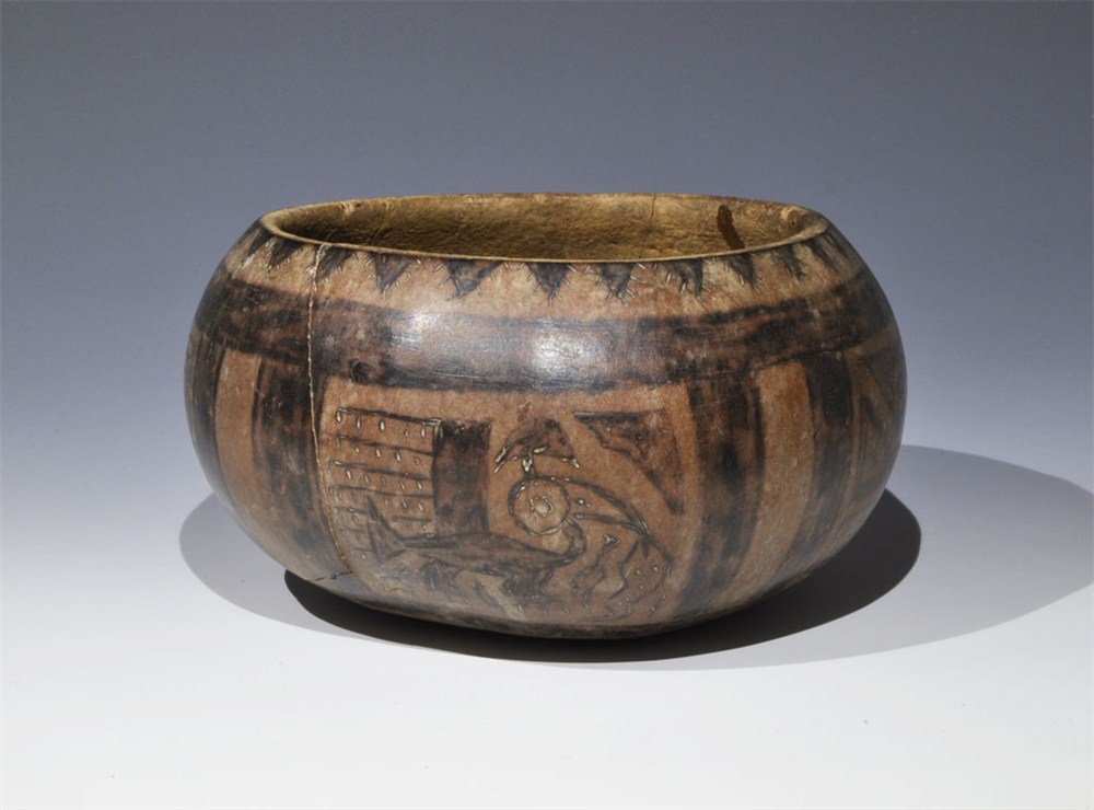 African Decorated Tribal Gourd Shell Bowl: 19th-20th century AD. A deep bowl formed from the shell of a gourd; the exterior with geometric patterning and zoomorphic motifs. Ex Douglas Rose collection. Gourd, 64 grams, 12.7 cm (5"). [No Reserve