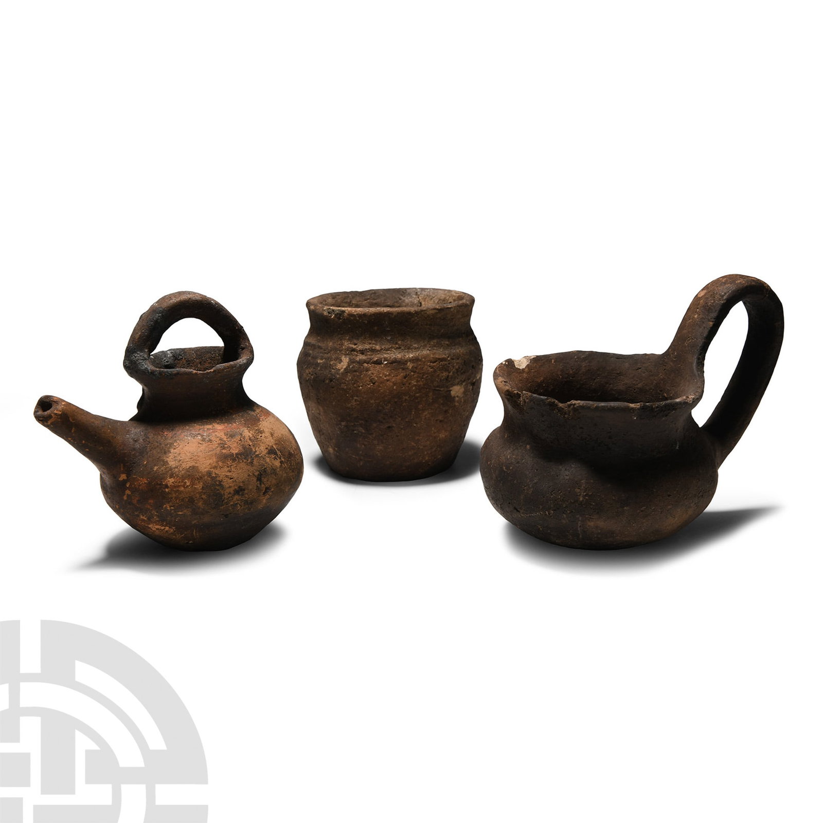 Cypriot Terracotta Flask Group: Early-Late Bronze Age, 2700-1200 B.C.. Comprising: a barrel-shaped jar with flared rim; a spouted vessel with strap handle; a dipper cup with flared rim. 625 grams total, 8.2-13.1 cm (3 1/4 - 5 1/8 in