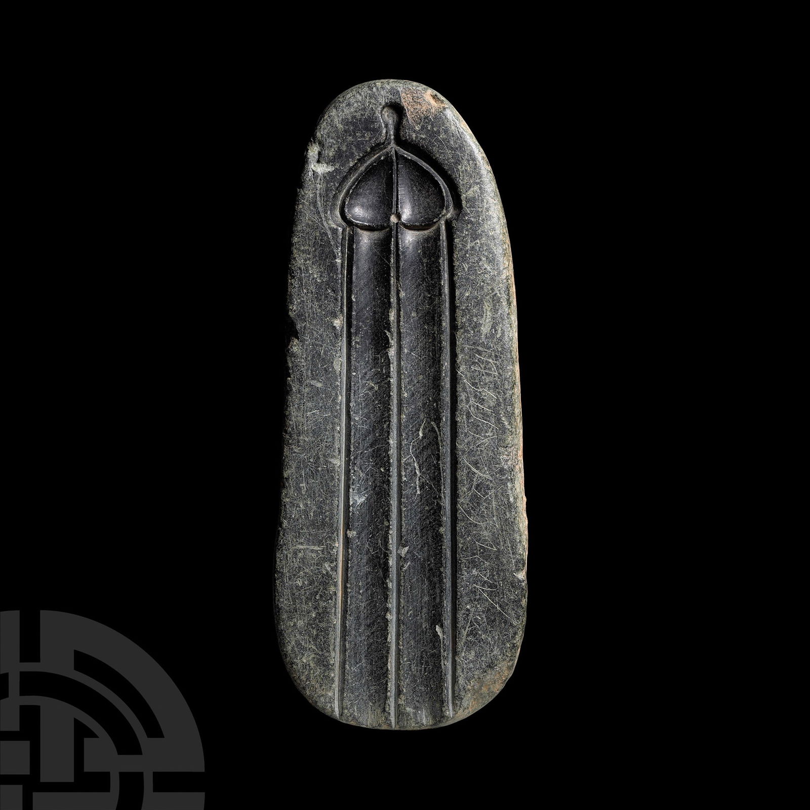 Late Medieval Stone Mould with Phallic Motif: 14th-16th century A.D.. A soapstone mould carved on one side with a phallic motif of an elongated double groove with domed top and projecting terminal, possibly for casting scabbard fittings; on the v