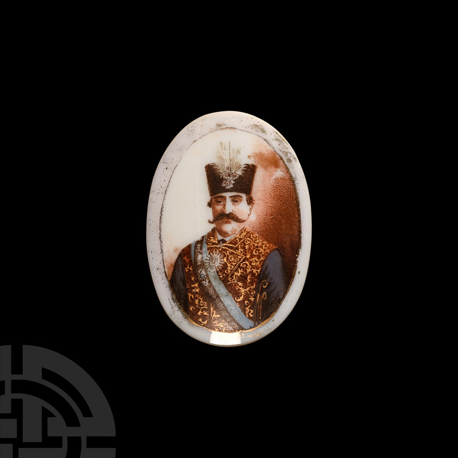 Qajar Portrait of Naser al-Din Shah: 19th century A.D.. Painted onto bone china in polychrome and gilt, showing the ruler facing, dressed in royal attire. 27 grams total, 64 mm high (82 x 82 mm including box) (2 1/2 in. (3 1/4 x 3 1/4 in