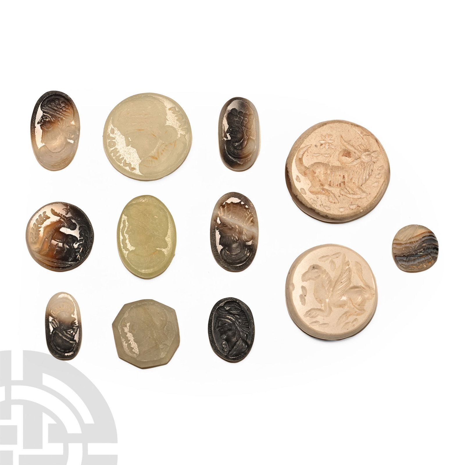 Gemstone Collection: 20th century AD.. Mainly discoid and ellipsoid cloisons with intaglio designs including mythical beast, profile bust and other types. 17 grams total, 9-21 mm (3/8 - 3/4 in.). Acquired on the UK art ma