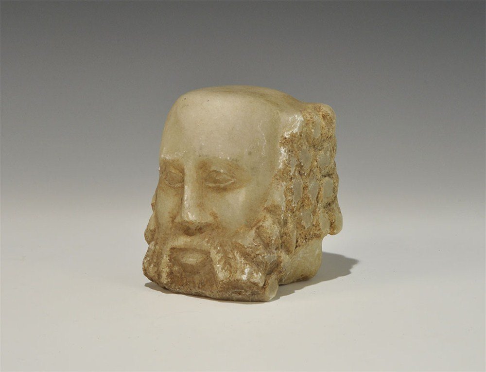 Near Eastern Yemen Alabaster Bust: 1st century BC or later A carved head from an alabaster statue depicting a fleshy-faced middle aged man with bald head and curly beard; the eyes carved lentoid with a broad nose and full mouth. 2.6 kg