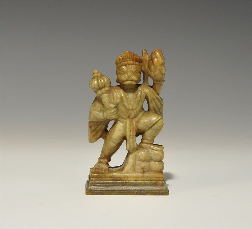 Chinese Soapstone Sun Wukong Figurine: 20th century AD. A carved figurine depicting the Monkey King, Sun Wukong, shown advancing onto a stone step, holding fruit, with a crown and necklace. 461 grams, 13 cm (5"). Private collection, Nottin