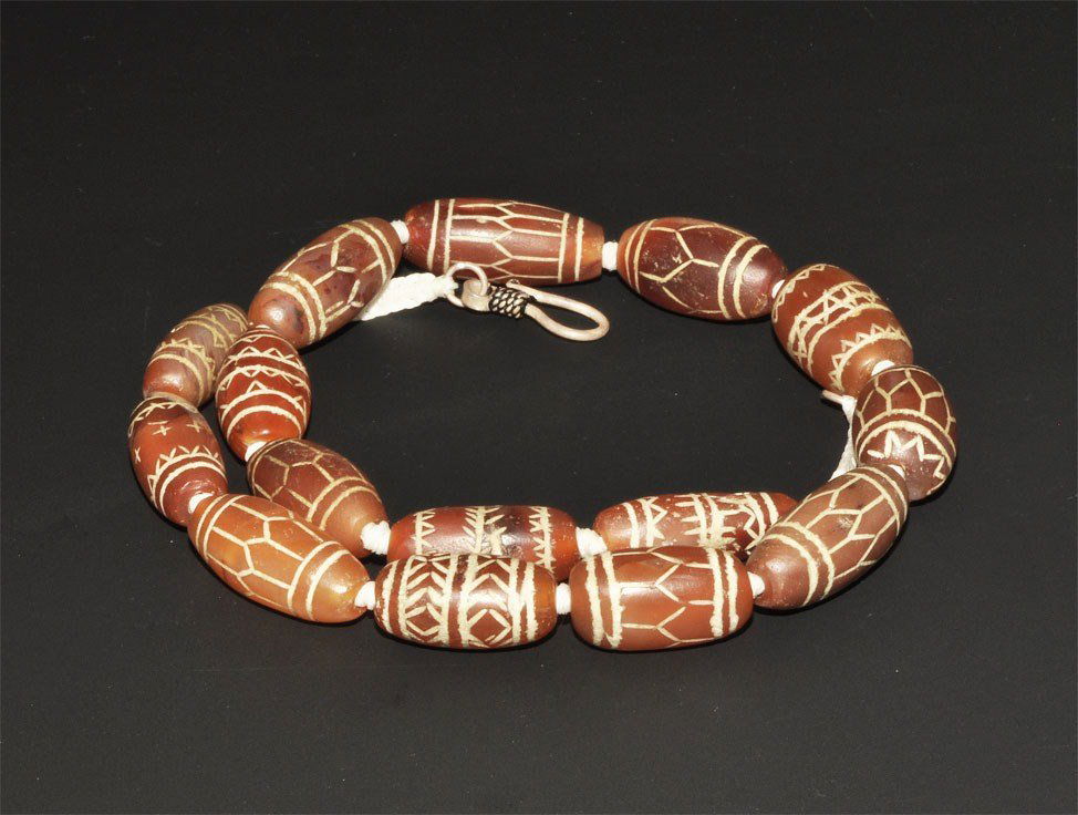 Near Eastern Afghan Turkoman Etched Carnelian Tribal Ne: Late 19th century AD. A restrung necklace of fifteen oblate carnelian beads with etched geometric designs; modern clasp. Stone, 67 grams, 46.5 cm (18 1/4"). Property of a London collector, acquired 19