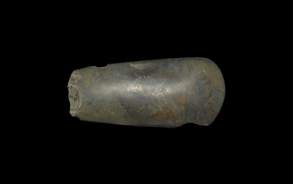 Stone Age English Polished Stone Axe: Neolithic, 5,000-3,000 BC. A well polished axe with convex cutting edge and slightly tapered sides in an attractive mottled grey-green hardstone, with label. 205 grams total, 12 cm (4 1/2"). Ex David 
