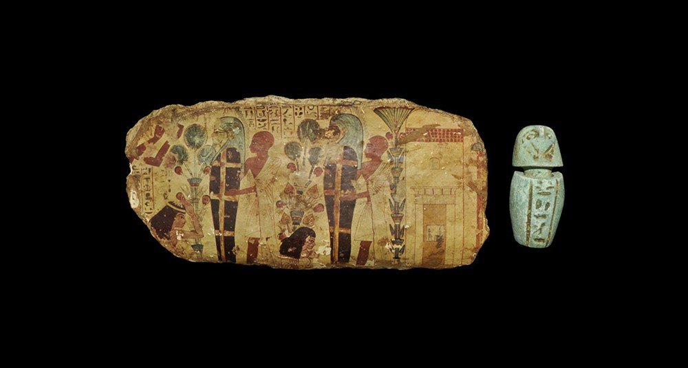 Egyptian Style Figural Cartonage Fragment and Miniature: A mixed group of undated archaistic artefacts comprising: a cartonage fragment with fabric backing faced with printed paper depicting a scene with mummies and attendants, hieroglyphic text above; a gl