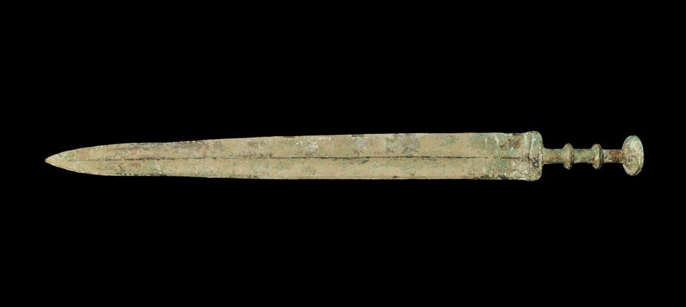 Chinese Style Bronze Han Sword: A cast sword in Han Dynasty style with tapering blade, slightly waisted above the tip; the hilt columnar with two flanges to the grip and larger concave flange pommel above; the guard lentoid in secti