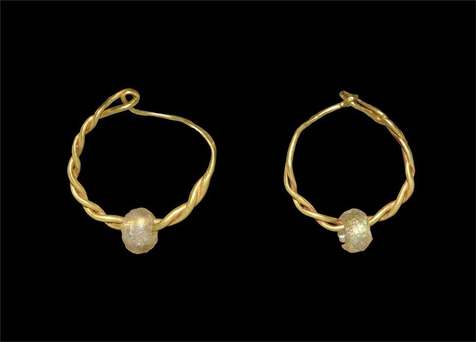 Roman Gold Double-Twisted Hoop Earring Pair: 1st-2nd century AD. A pair of Type I gold earrings each formed as a double-twisted hoop with an iridescent glass seed bead. 1.14 grams, 17-18 mm (3/4"). Cf. Marshall, F.H. Catalogue of the Jewellery G