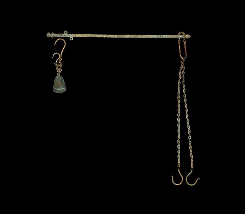 Byzantine Bronze Steelyard Balance: 9th-12th century AD. A square-section steelyard with graduations marked on three faces, knop ends and three loops; lead-filled bronze weight with chain and hook; loop, two chains and hooks. 944 grams,