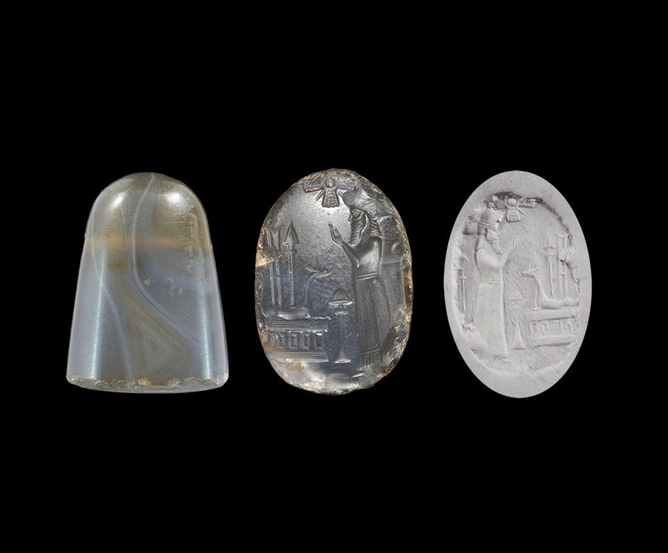 Near Eastern Neo-Babylonian Mushhushu-Dragon Stamp Seal: 626-539 BC. A hardstone ellipsoid stamp seal with design depicting a standing bearded robed male, facing an altar with reclining mushhushu-dragon and an incense burner. 23 grams, 18 mm (3/4"). Propert