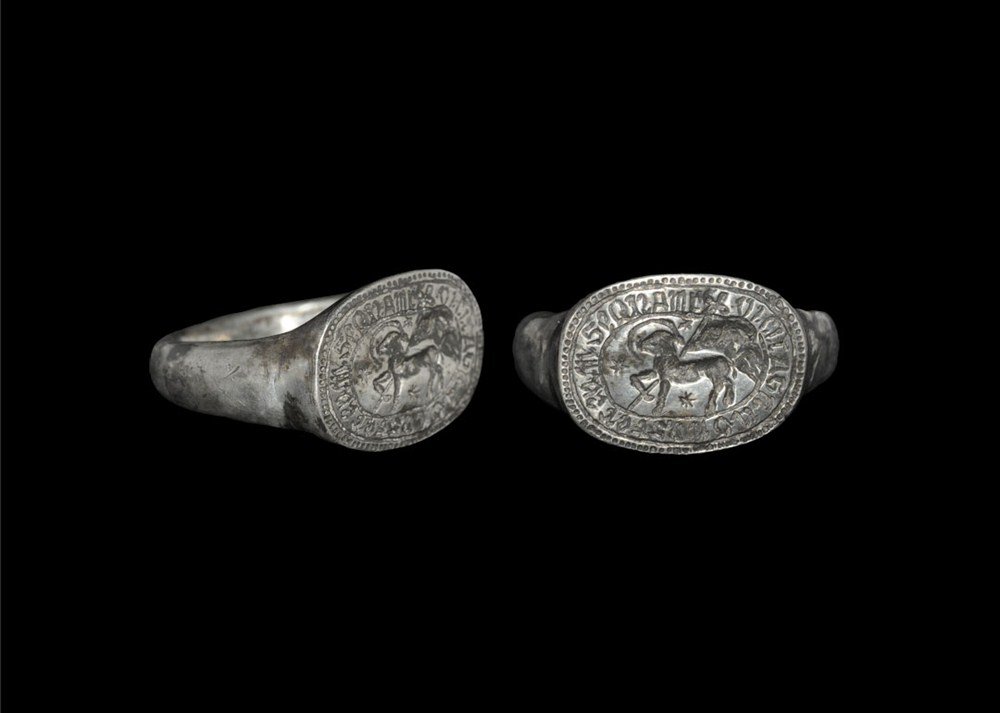 Post Medieval Silver Epigraphic 'Agnus Dei' Finger Ring: 17th century AD. A cast finger ring with round-section hoop and elliptical bezel depicting an agnus dei with crescent moon and stars; to the border, the text SEQNAM VICIT AGNU D NOSTER EAM translating