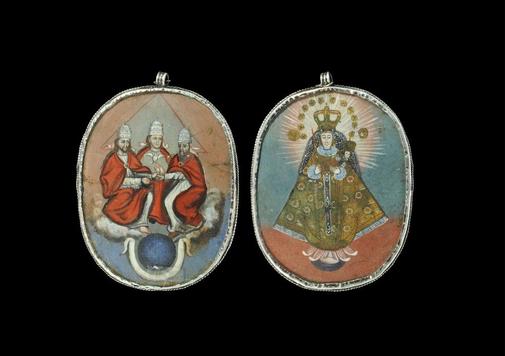 Post Medieval Large Reverse-Enamelled Magi and Madonna : 17th-18th century AD. A large bifacial pendant in a white metal frame with ribbed loop above and ropework border; to one face a reverse-enamelled image of the three magi in white robes with red cloaks
