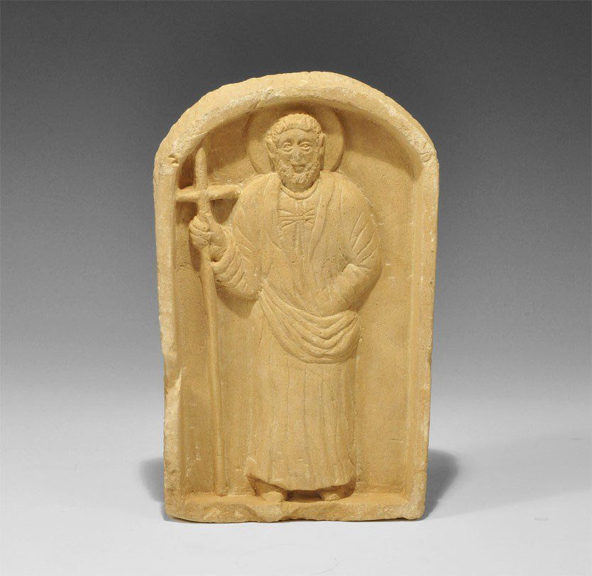 Byzantine Stone Nimbate Figural Plaque: Late 10th century AD. A carved stone plaque depicting a standing robed and nimbate saint within an arch, grasping a cross in his right hand. 1.5 kg, 20.5 cm (8"). Silk collection, London, UK; formed i