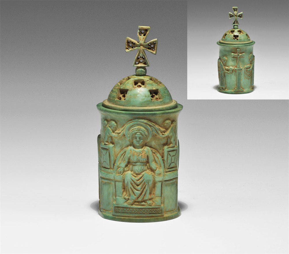 Byzantine Style Carved Ivory Lidded Pyxis: 18th-19th century AD. A carved dyed ivory lidded vessel with figural scenes to the body; the lid domed with ten equidistant rectangular recesses, each with five drilled holes, surmounted by a ball and